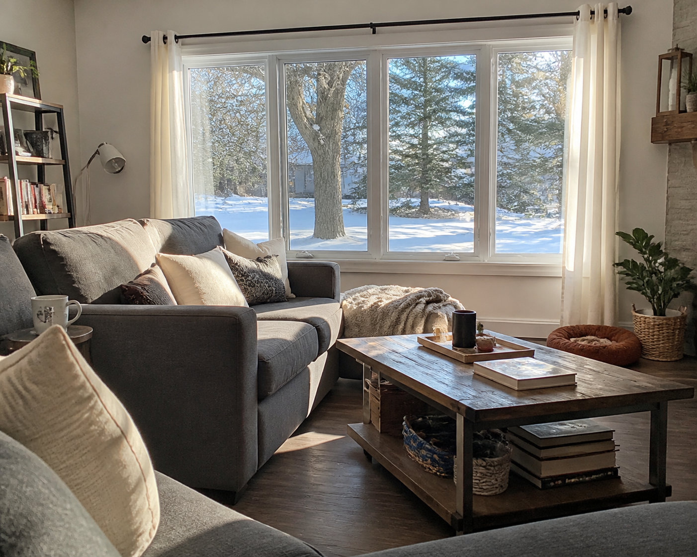 Bright Ontario living room with large vinyl windows on a cold sunny day, cozy seating and soft winter light coming through clear glass