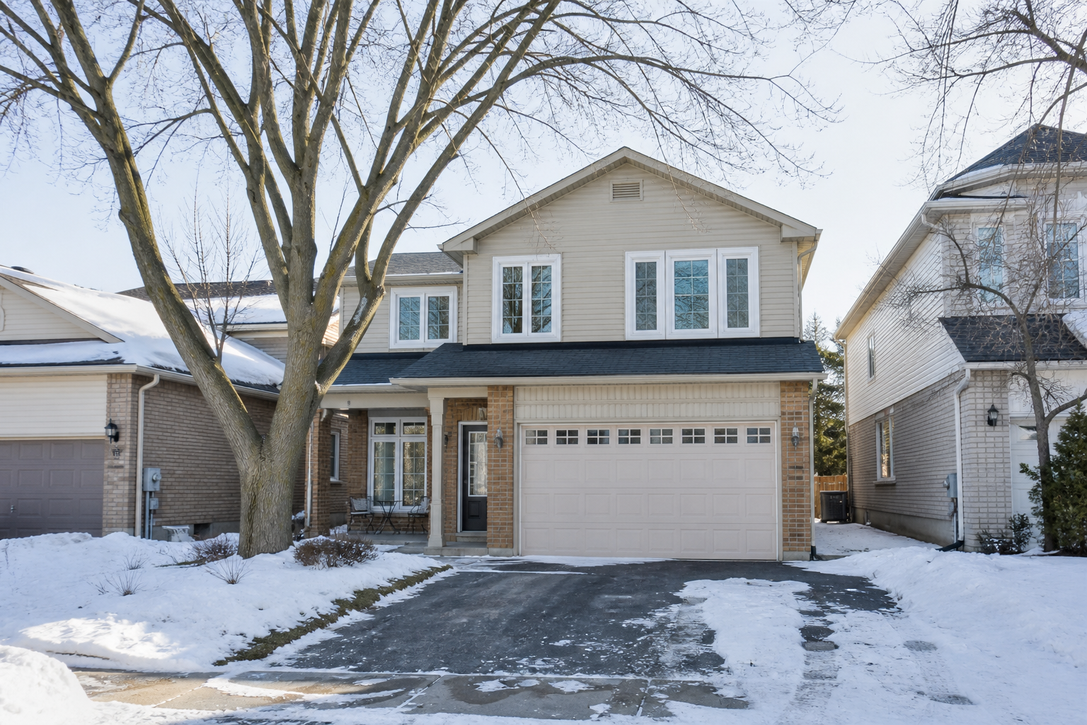 Exterior of a Canadian suburban home with updated windows in winter light