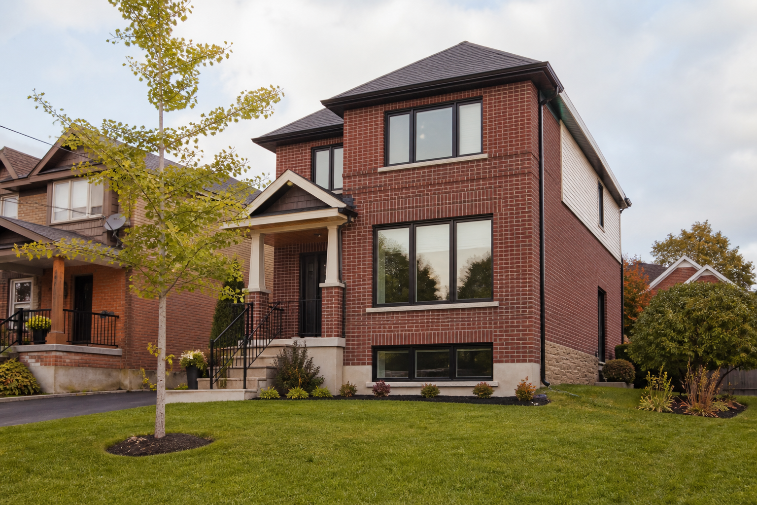 Exterior of an Ontario brick house with a mix of living room, bedroom, and basement windows