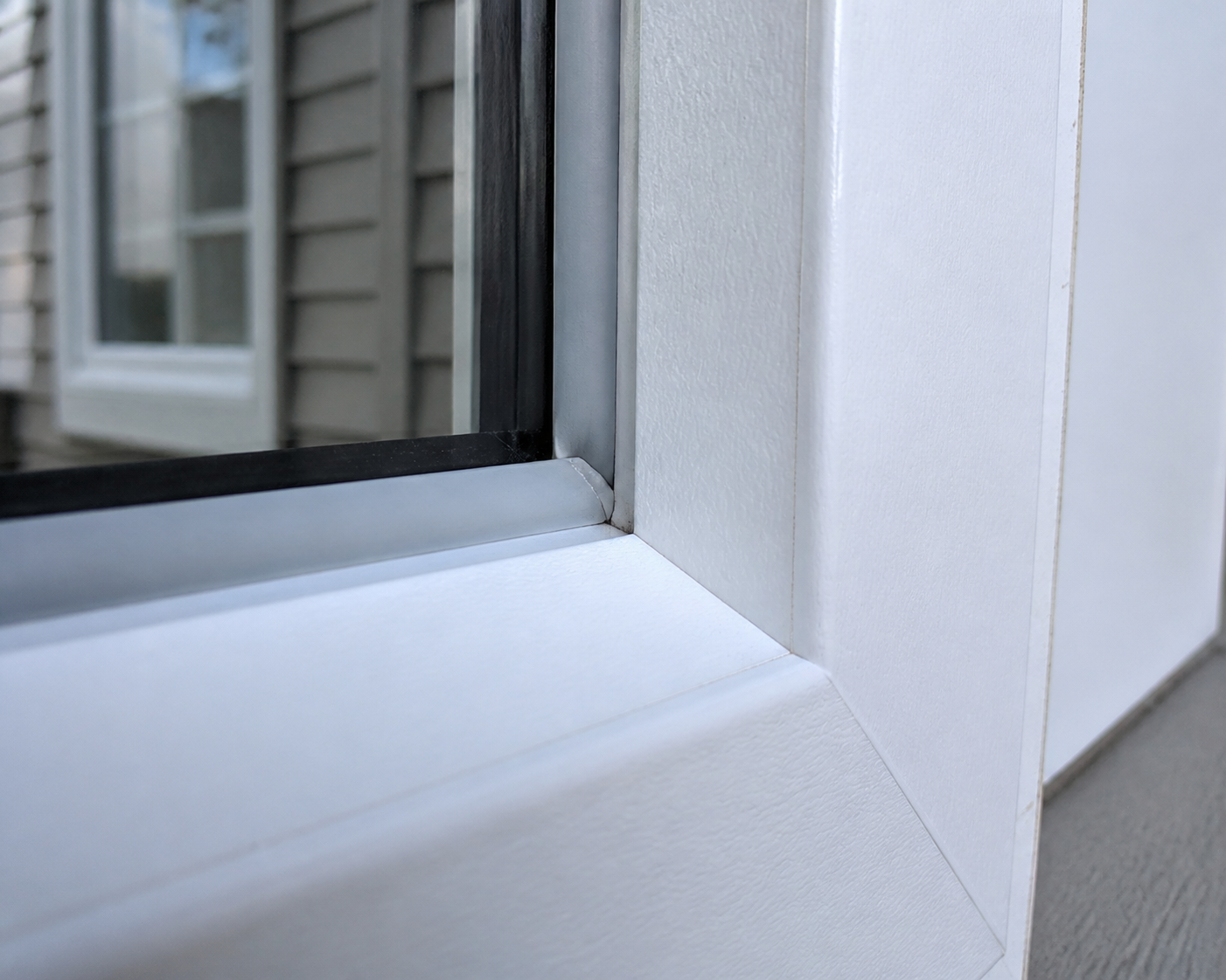 Macro close-up of vinyl window weatherstripping and frame corner seal